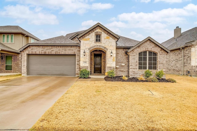 french provincial home with a garage