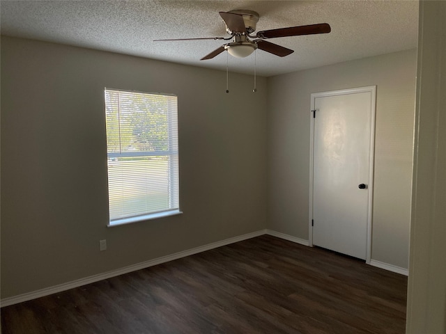 spare room with dark hardwood / wood-style flooring, ceiling fan, and a textured ceiling