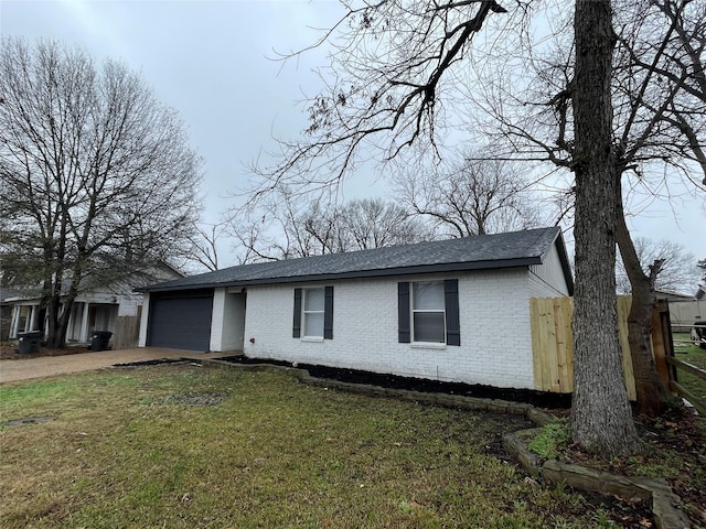 single story home featuring a garage and a front yard