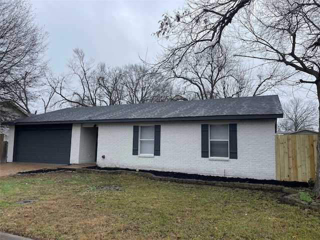 single story home with a garage and a front lawn