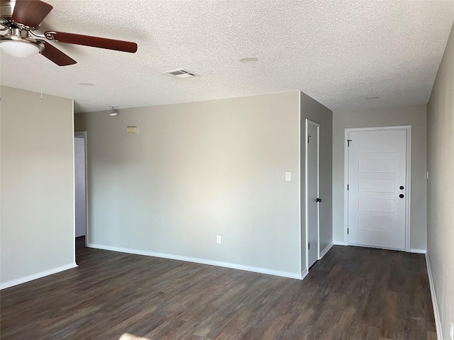 unfurnished room with ceiling fan, dark hardwood / wood-style floors, and a textured ceiling