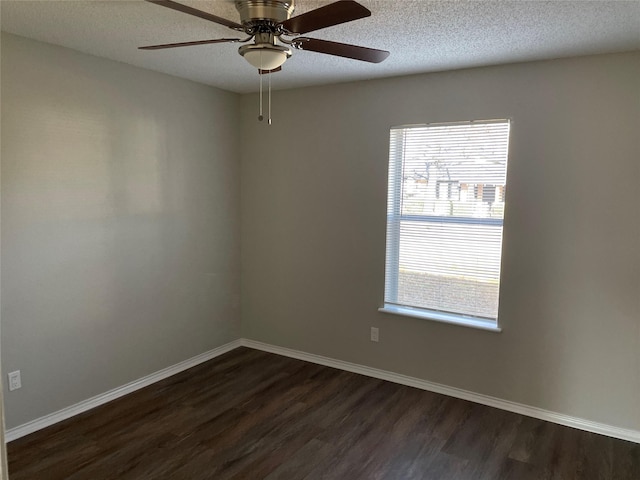 empty room featuring dark hardwood / wood-style flooring and a textured ceiling