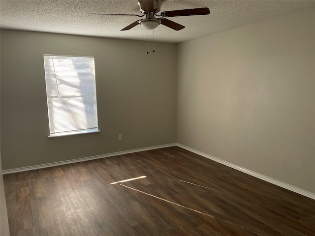 empty room with ceiling fan, dark hardwood / wood-style floors, and a textured ceiling