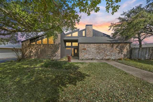 back house at dusk with a yard