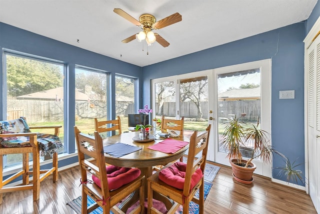 dining room with wood-type flooring and ceiling fan