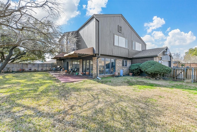 rear view of house with a yard and a patio