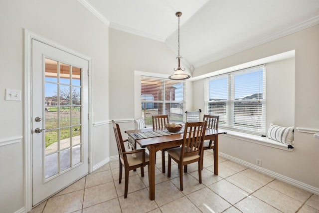 dining space featuring crown molding, vaulted ceiling, and light tile patterned floors