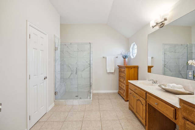 bathroom featuring lofted ceiling, vanity, tile patterned floors, and walk in shower