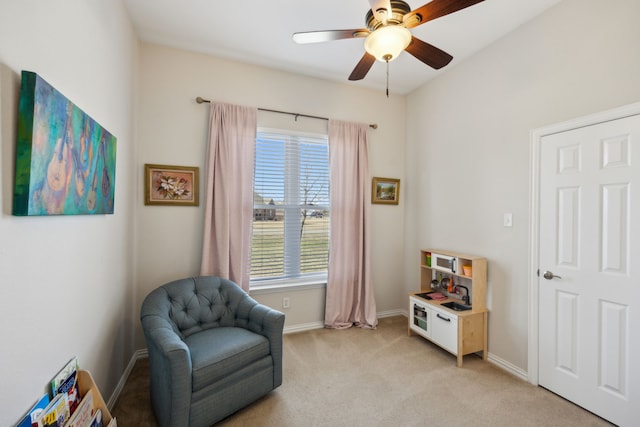 living area with light colored carpet and ceiling fan