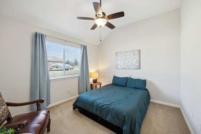 bedroom featuring ceiling fan, vaulted ceiling, and light carpet