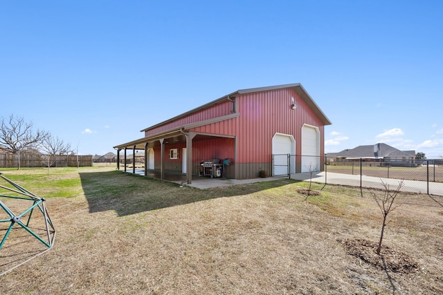 view of outbuilding with a garage and a lawn