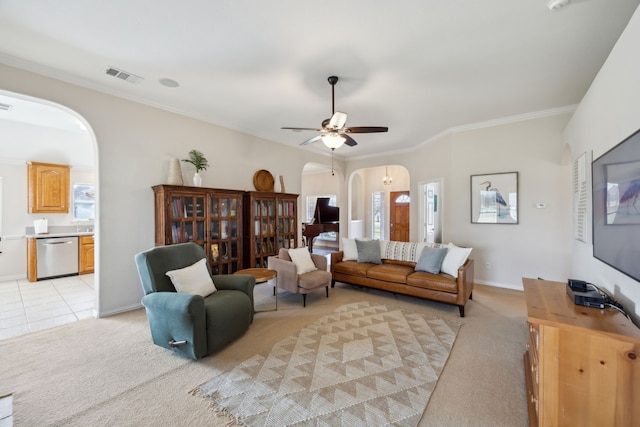 living room with ornamental molding, light carpet, and ceiling fan