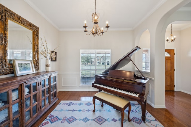 misc room featuring crown molding, hardwood / wood-style floors, and a notable chandelier