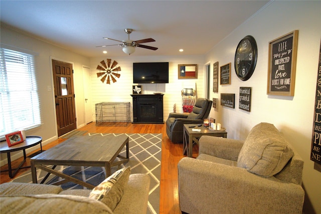 living room featuring hardwood / wood-style floors and ceiling fan