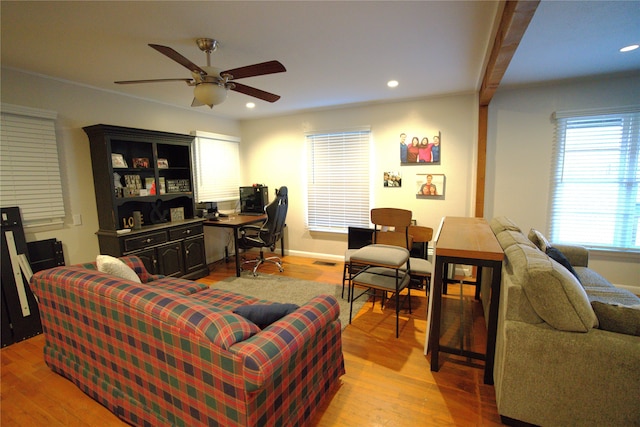 living room with light hardwood / wood-style floors and ceiling fan