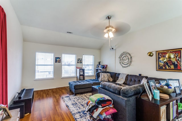 living room with ceiling fan, lofted ceiling, and dark hardwood / wood-style floors