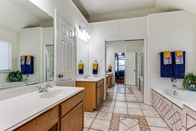 bathroom with vanity, vaulted ceiling, and tile patterned floors