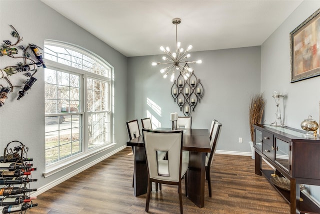 dining area with an inviting chandelier and dark hardwood / wood-style flooring