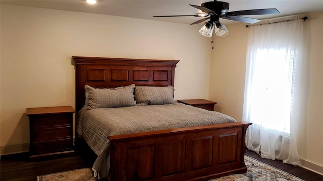 703 San Jacinto St, Mineral Wells, TX 76067 - bedroom featuring dark wood finished floors, baseboards, and a ceiling fan