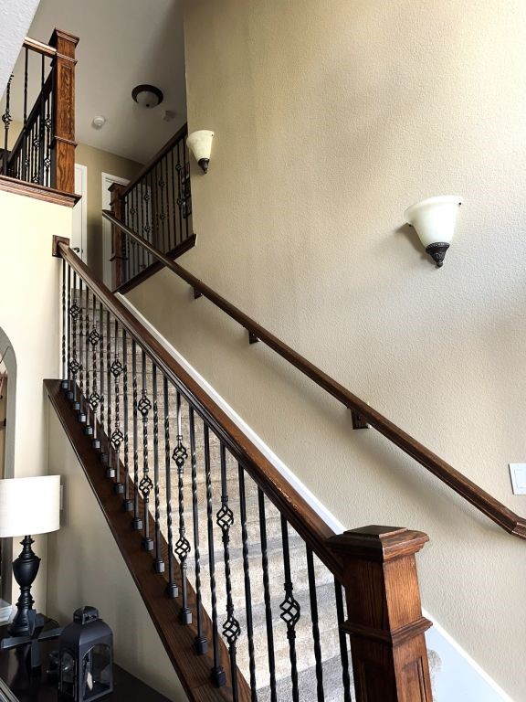 staircase with a high ceiling