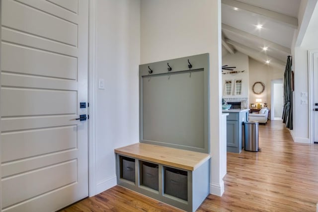 mudroom with vaulted ceiling with beams, light hardwood / wood-style flooring, and ceiling fan