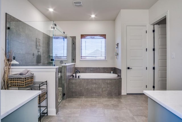 bathroom with tile patterned floors, vanity, and separate shower and tub