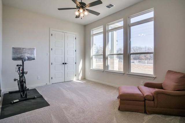 sitting room featuring ceiling fan and carpet