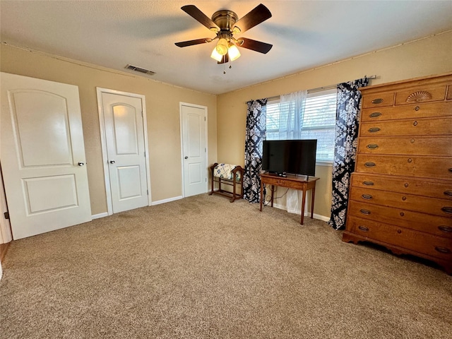 misc room with carpet and ceiling fan