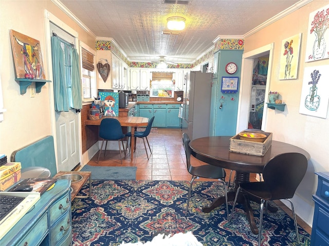 dining space featuring crown molding and light tile patterned floors