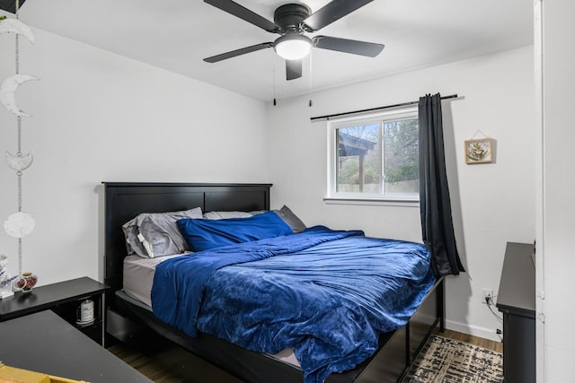 bedroom with dark wood-type flooring and ceiling fan