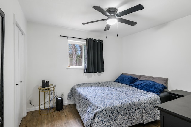 bedroom featuring dark hardwood / wood-style floors and ceiling fan