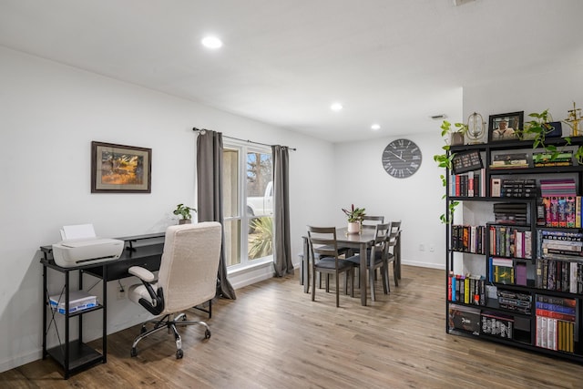 office space with wood-type flooring