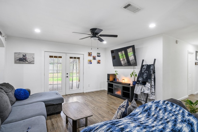 living room featuring french doors, ceiling fan, and hardwood / wood-style flooring