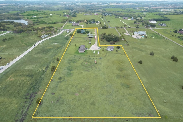 birds eye view of property with a rural view and a water view