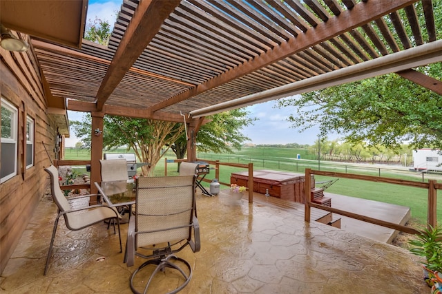 view of patio / terrace with a pergola and a rural view