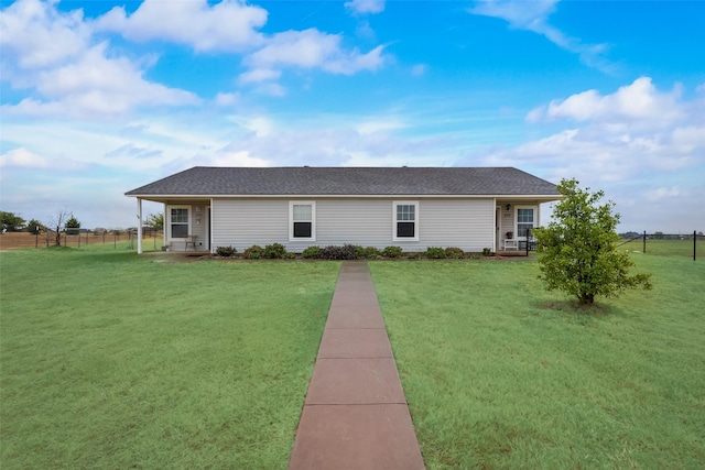 rear view of house featuring a lawn