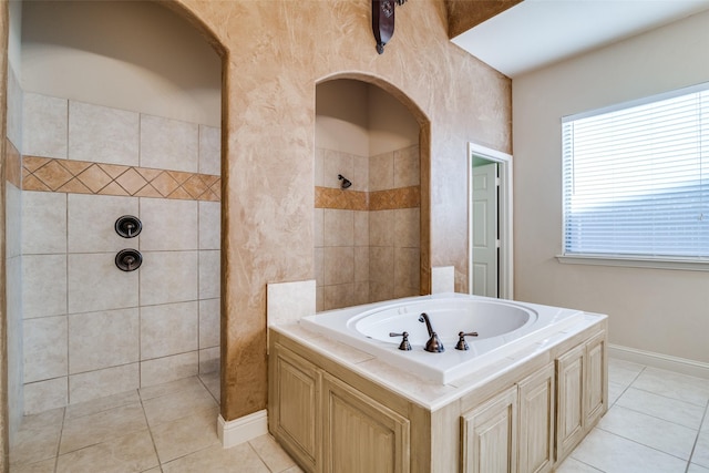 2605 Waterstone Ln, Rockwall, TX 75032 - bathroom featuring tile patterned floors, a tile shower, a bath, and baseboards