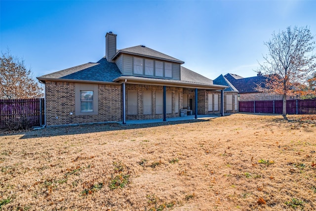 2605 Waterstone Ln, Rockwall, TX 75032 - back of property featuring brick siding, a shingled roof, a patio, and a chimney