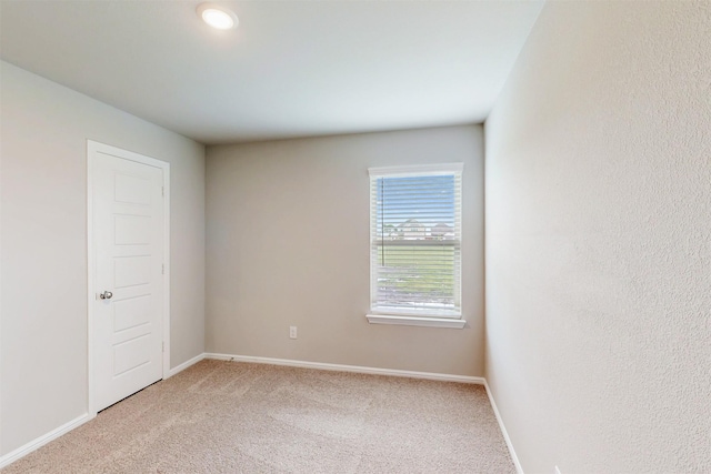 716 Tawny Turn, Lavon, TX 75166 - spare room featuring baseboards and light carpet