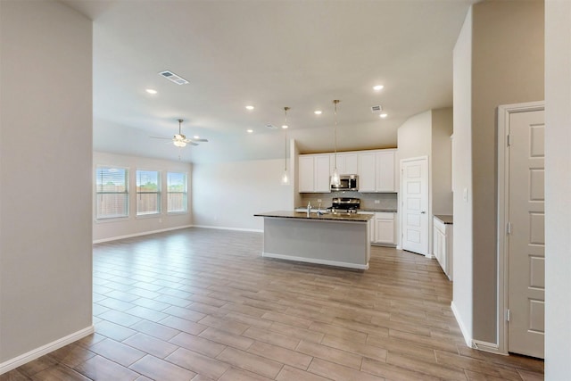 716 Tawny Turn, Lavon, TX 75166 - kitchen with visible vents, range, baseboards, stainless steel microwave, and open floor plan