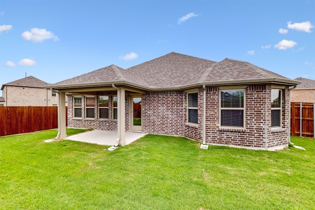716 Tawny Turn, Lavon, TX 75166 - back of property featuring a lawn, a fenced backyard, roof with shingles, and a patio
