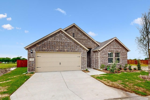 716 Tawny Turn, Lavon, TX 75166 - view of front of house with a front lawn, fence, brick siding, concrete driveway, and an attached garage