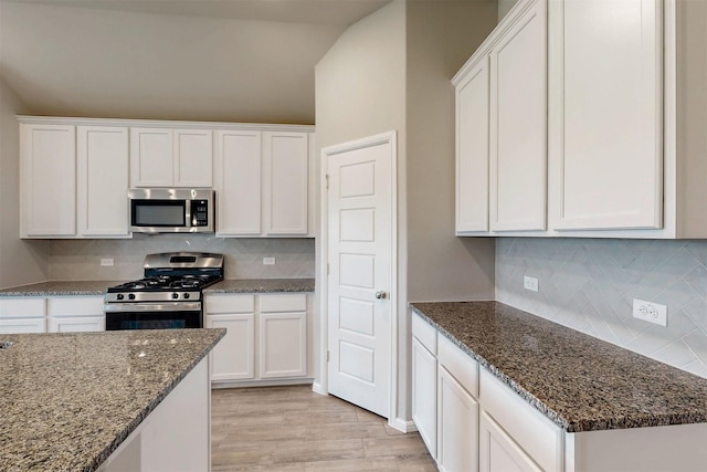 716 Tawny Turn, Lavon, TX 75166 - kitchen featuring white cabinets, light wood-style flooring, dark stone countertops, stainless steel appliances, and tasteful backsplash