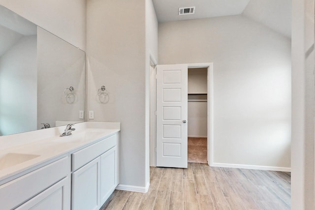 721 Merry Summit Rd, Lavon, TX 75166 - full bathroom with double vanity, wood finished floors, lofted ceiling, baseboards, and a spacious closet