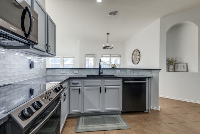 kitchen with sink, hanging light fixtures, black dishwasher, decorative backsplash, and stainless steel electric stove