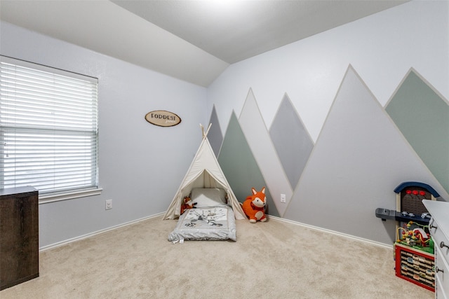 rec room with vaulted ceiling and light colored carpet