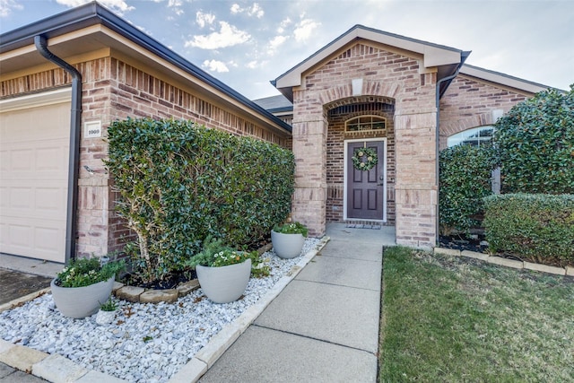 doorway to property with a garage