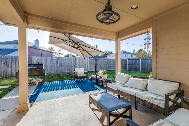 view of patio with an outdoor living space and ceiling fan