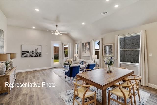 dining area with lofted ceiling, ceiling fan, and light wood-type flooring