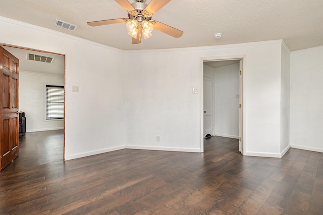 empty room with dark hardwood / wood-style flooring, ceiling fan, ornamental molding, and a textured ceiling